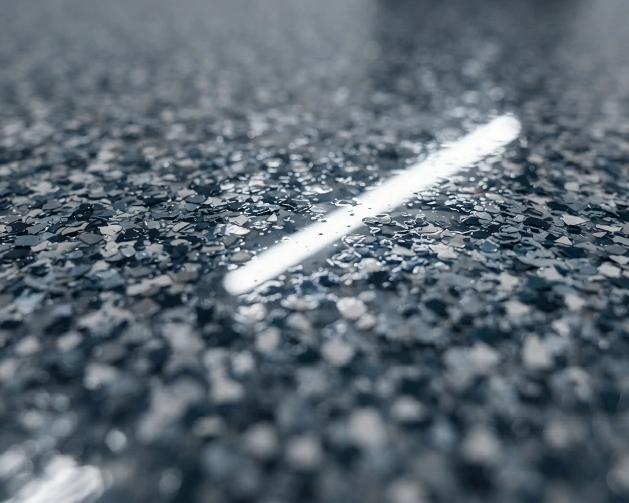 Polyaspartic clear-coat sheen over a flake floor.